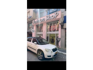 White Car in Front of Fashion Shop